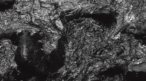 Image of a creek, cropped version, showing sunlight reflections. Photo by Eduardo Libby