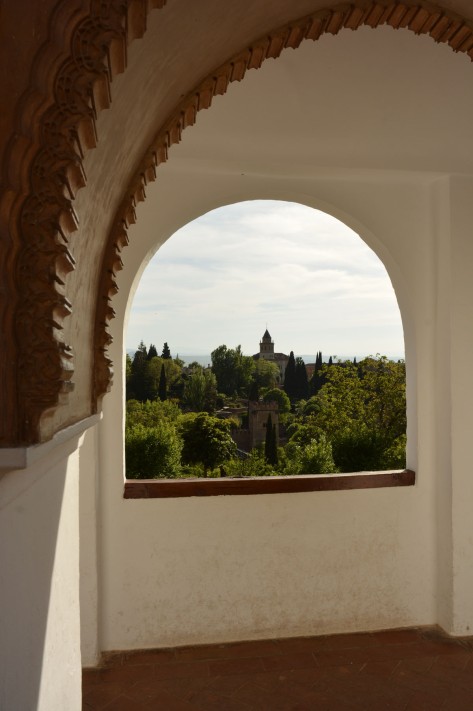 Garden view through an arched window of The Alhambra. Photo by Eduardo Libby