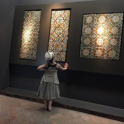 Image of a lovely-dressed young girl admiring classic tiles from Seville's Alcazar. Photo by Eduardo Libby.