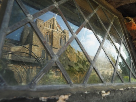 Window refelction of buildings near Winchester College. Photo by Eduardo Libby