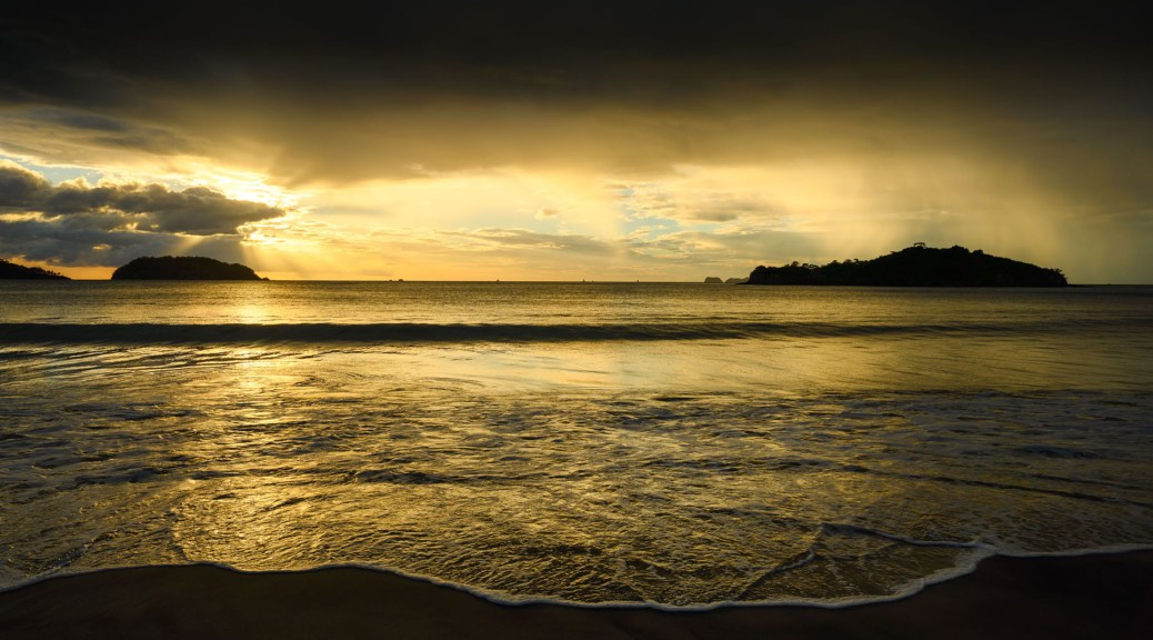Sunset in Penca Beach, Guanacaste, Costa Rica showing distant rain. Photo by Eduardo Libby